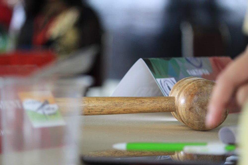 Judge’s gavel on desk with lease documents and tenant forms nearby.