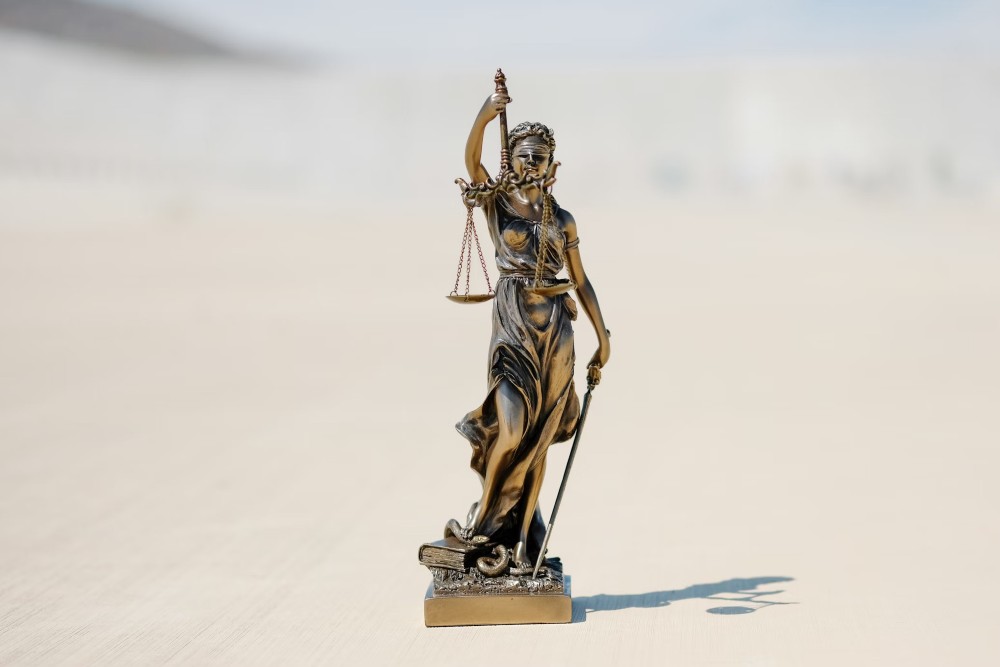 Bronze Lady Justice statue with scales and sword, symbolizing fairness and the rule of law.