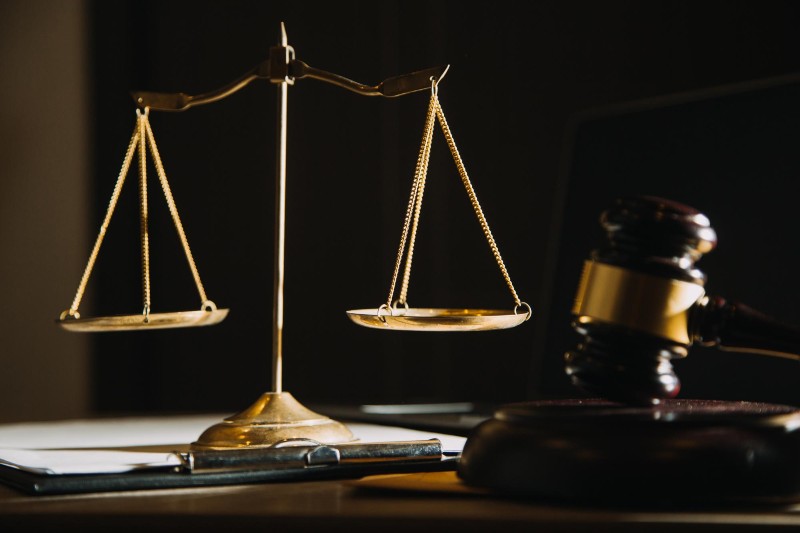 Close-up of justice scales and gavel on a desk, symbolizing legal decisions and tenant rights in gentrification-related cases.