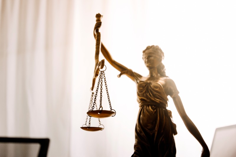 Close-up of Lady Justice statue symbolizing impartiality and legal rights in housing and rental law.